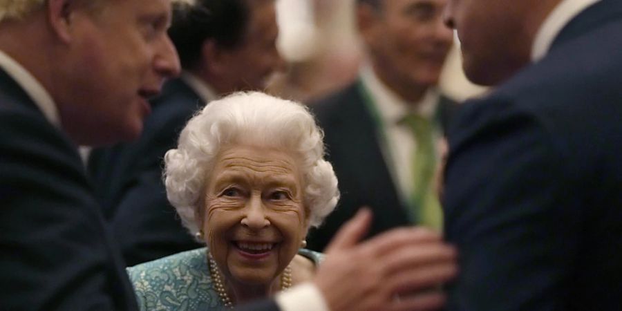 ARCHIV - Die britische Königin Elizabeth II. und Premierminister Boris Johnson (l) begrüssen die Gäste bei einem Empfang anlässlich des Global Investment Summit in Windsor Castle. Foto: Alastair Grant/AP Pool/dpa