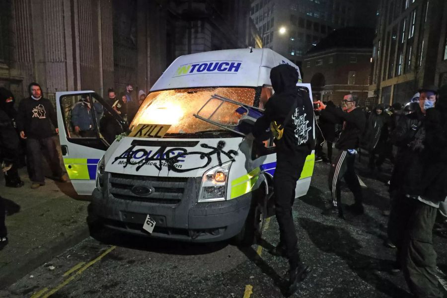 Demonstranten in Bristol setzten am Sonntag ein Polizeifahrzeug in Brand.