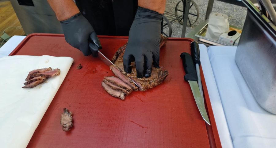 Der Sous-Chef schneidet das Fleisch direkt in der gewünschten Menge zu serviergerechten Stücken.