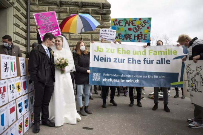 Demonstranten, hinten, protestieren bei der Einreichung der Unterschriften für das Referendum «Nein zur Ehe für alle», am Montag, 12. April 2021, in Bern. Ehe für alle Referendum