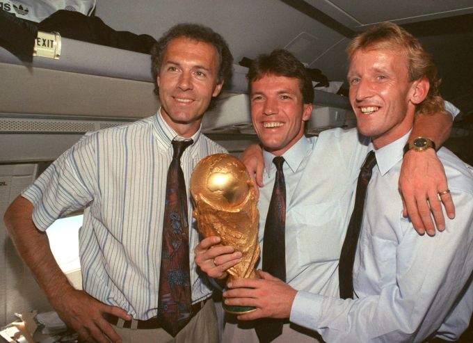Andreas Brehme (rechts) nach dem WM-Titel 1990 mit Lothar Matthäus (Mitte) und Franz Beckenbauer (†78). Andreas Brehme