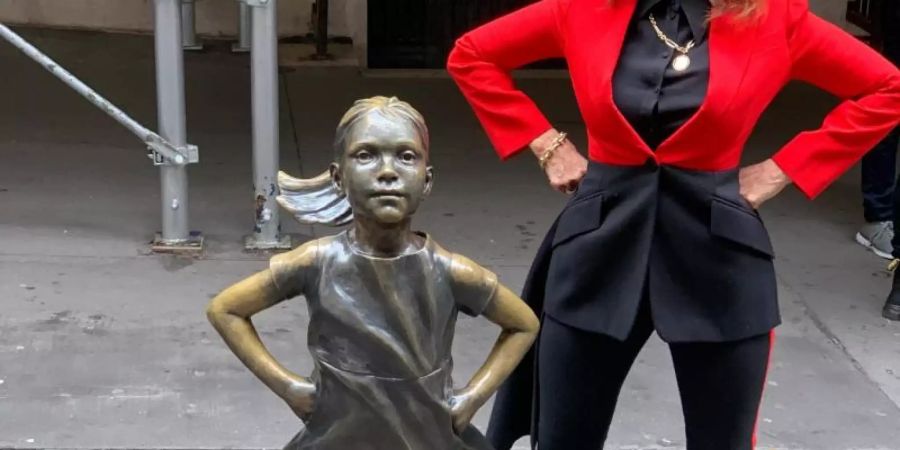 Die Statue «Fearless Girl»: Neben ihrem bekannten Werk steht die Bildhauerin Kristen Visbal. Foto: Benno Schwinghammer/dpa