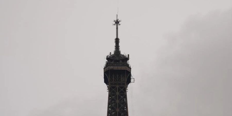 Ein Hubschrauber installiert die neue Antenne auf der Spitze des Eiffelturms. Foto: Francois Mori/AP/dpa
