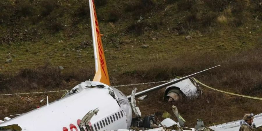 Ein Soldat bewacht das Wrack des verunglückten Flugzeugs der Pegasus Airlines. Foto: Emrah Gurel/AP/dpa