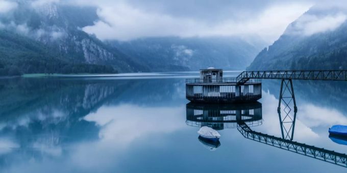 Der spiegelglatte See mit der Wasserfassung des Kraftwerks am Loentsch am Kloentalersee (Symbolbild). Wasserfassung
