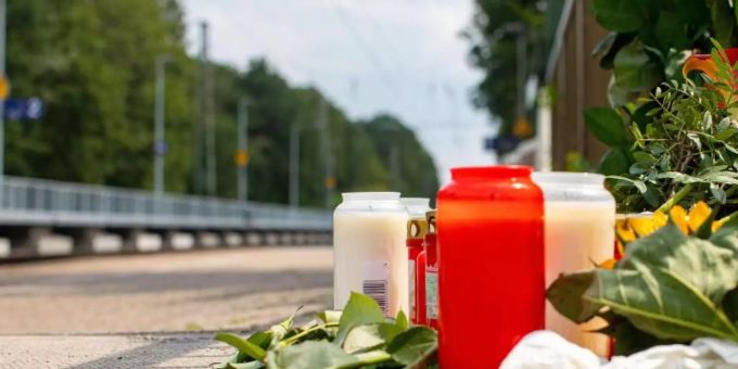 Blumen und Kerzen stehen an Gleisen. (Symbolbild) opferhilfe