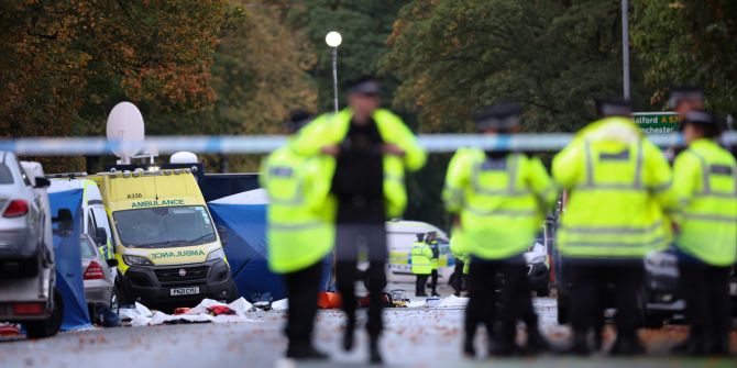 Police officers investiate the scene of a fatal vehicle and stabbing attack on Manchester synagogue