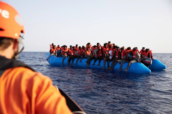Die von der Seenotrettungsorganisation Sea-Eye herausgegebene Aufnahme zeigt einen Seenotretter (l) der zu einem Flüchtlingsboot schaut. Die Innenminister der EU tauschen sich heute (07.07.) in einer Videokonferenz zur Polizeizusammenarbeit und zur Seenotrettung aus. (Archivbild) Foto: Fabian Heinz/Sea-Eye/dpa Seenotrettung im Mittelmeer
