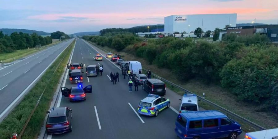 Polizisten und Helfer stehen mit ihren Fahrzeugen auf der Autobahn 9. Foto: Ralph Goppelt/Vifogra/dpa