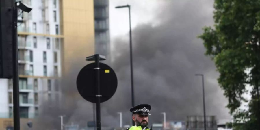 Polizisten richteten einen Sicherheitsbereich um den Brand in der Nähe des Bahnhofs Elephant and Castle in Süd-London ein. Foto: Tayfun Salci/ZUMA Wire/dpa