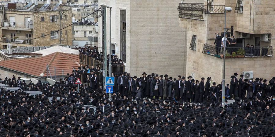 Tausende von ultraorthodoxen Juden nehmen an der Beerdigung des Rabbiners Meshulam Dovid Soloveitchik teil. Foto: Ariel Schalit/AP/dpa