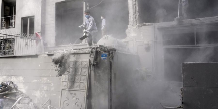 dpatopbilder - Freiwillige räumen in den Trümmer eines Wohnhauses, das beschädigt wurde, als eine nahe gelegene Polizeistation am Freitag bei einem amerikanisch-israelischen Angriff ...