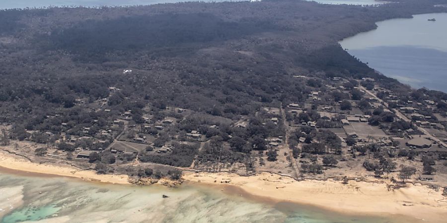 Blick aus einem P-3K2 Orion Flugzeug über einem Gebiet von Tonga mit Asche auf Hausdächern und angrenzender Vegetation, am Montag, 17. Januar 2022. (AAP Image)