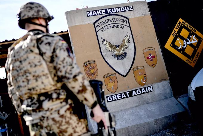 Ein US-Soldat steht vor einem Mauerteil mit der Aufschrift «Make Kunduz Great Again». afghanistan usa