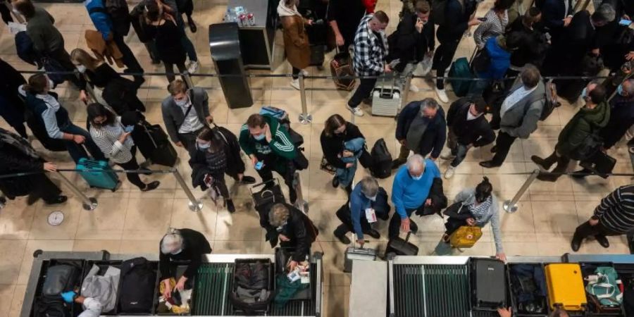 Passagiere an einer Sicherheitskontrolle des Flughafen BER. Foto: Christophe Gateau/dpa