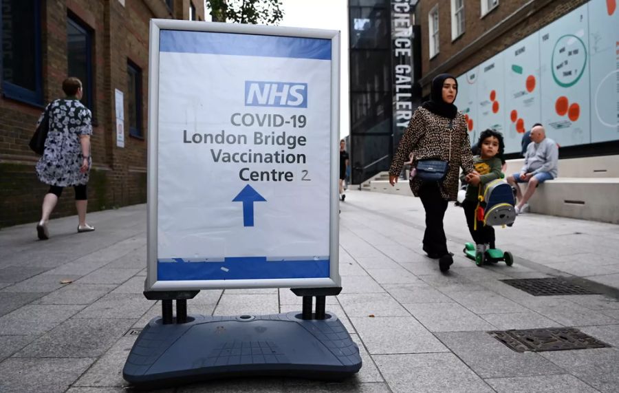 Ein Schild in London zeigt in Richtung Corona-Impfzentrum an der Tower Bridge.