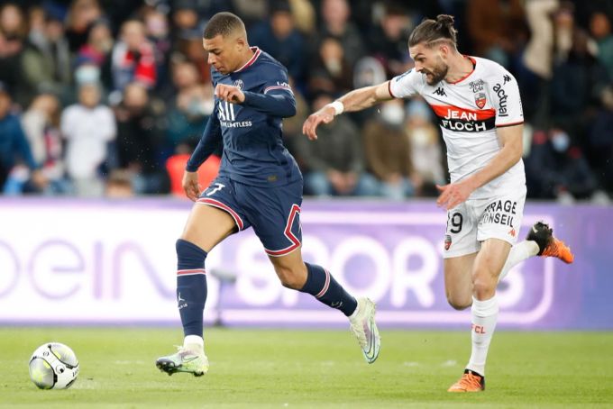 Kylian Mbappe wird von Lorients Leo Petrot (r) verfolgt. Ligue 1