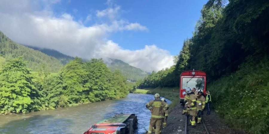 HANDOUT - In Österreich ist ein Zug mit Dutzenden Kindern und Jugendlichen an Bord entgleist und in einen Fluss gestürzt. Foto: -/FREIWILLIGE FEUERWEHR TAMSWEG/APA/dpa - ACHTUNG: Nur zur redaktionellen Verwendung im Zusammenhang mit der aktuellen Berichterstattung und nur mit vollständiger Nennung des vorstehenden Credits