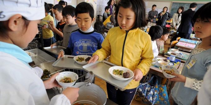 Schüler holen sich in einer Schulkantine in Tokio ihr Mittagsessen. (Archivbild) japan schule