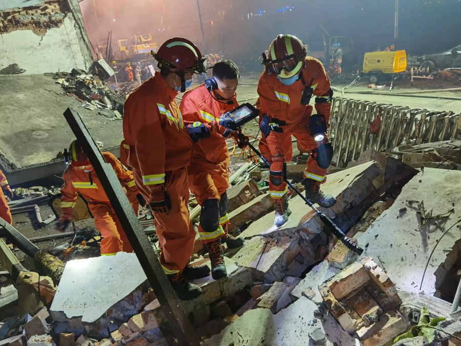 Rettungskräfte arbeiten an einem beschädigten Gebäude nach der Explosion eines Öltankers in Wenling, Provinz Zhejiang, China.