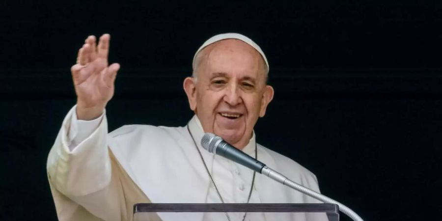 Papst Franziskus winkt aus dem Fenster seines Arbeitszimmers mit Blick auf den Petersplatz einer Menge von Gläubigen und Pilgern zu. Foto: Domenico Stinellis/AP/dpa