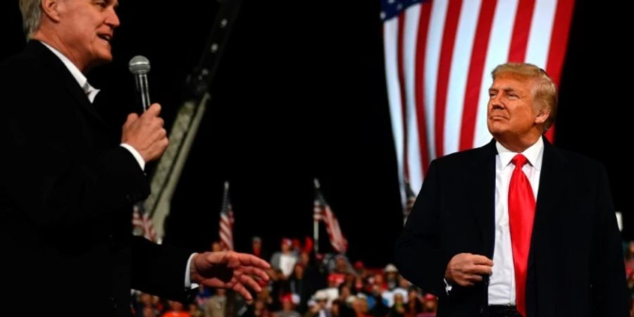 Perdue (l.) und Trump