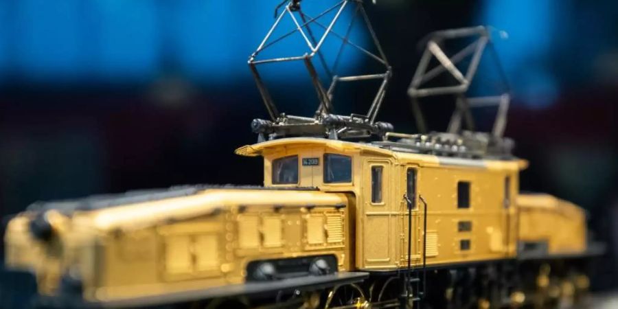 Eine vergoldete Güterzug-Elektrolokomotive von Märklin auf dem Stand des Unternehmens bei der Nürnberger Spielwarenmesse. Foto: Daniel Karmann/dpa