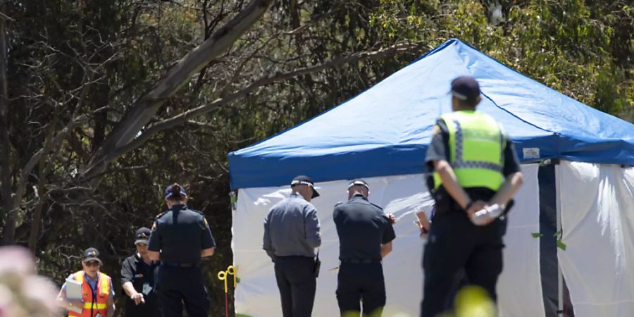 Worksafe Tasmania officers (left) inspect the jumping castle  at Hillcrest Primary School in Devonport, Tasmania, Thursday, December 16, 2021. Several children have suffered serious injuries in northwest Tasmania after falling about 10 metres from a jumping castle that was blown into the air. (AAP Image/Grant Wells) NO ARCHIVING