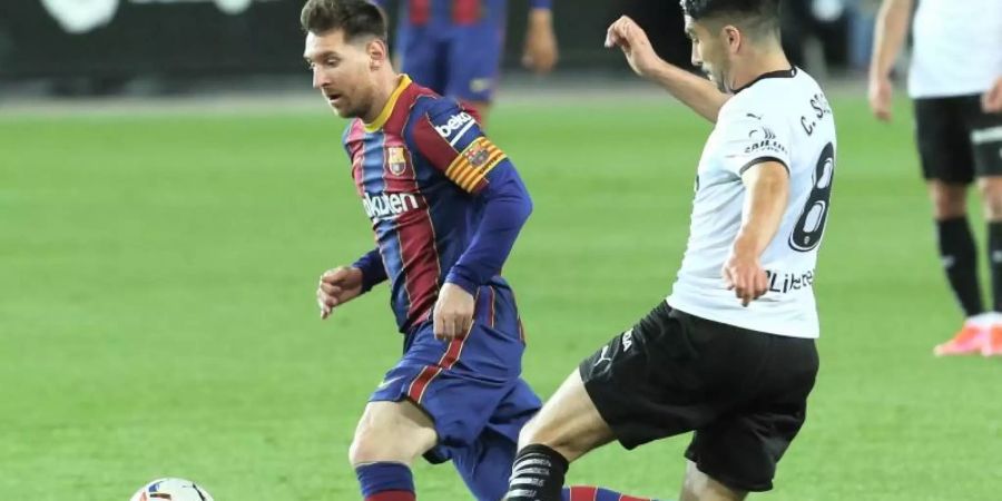 Barcelonas Lionel Messi (l) im Duell mit Valencias Carlos Soler. Foto: Alberto Saiz/AP/dpa