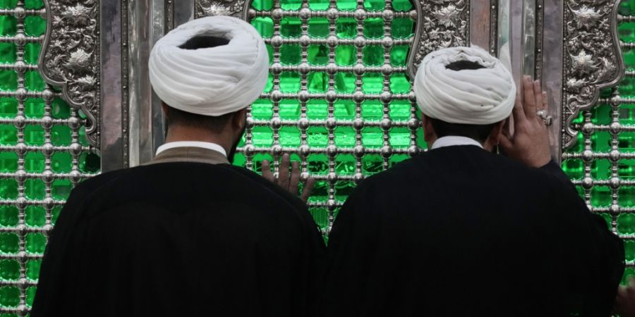 ARCHIV - Kleriker beten in Schahr-e-Rai, südlich von Teheran, während sie die Gitterstäbe des Grabes des schiitischen Heiligen Hamsah berühren. Foto: Vahid Salemi/AP/dpa/Symbolbild