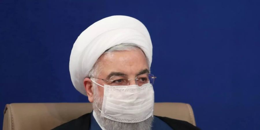 HANDOUT - Hassan Ruhani, Präsident des Iran, leitet eine Kabinettssitzung und trägt dabei eine Maske. Foto: -/Iranian Presidency/dpa - ACHTUNG: Nur zur redaktionellen Verwendung und nur mit vollständiger Nennung des vorstehenden Credits